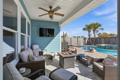 Covered outdoor lounge and dining area beside the private pool—ideal for family vacations.