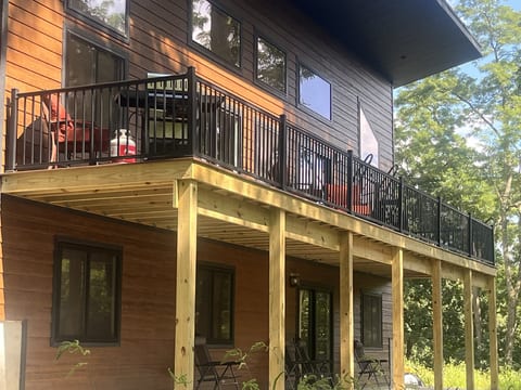 Spacious upper deck surrounded by the trees—perfect for relaxing and enjoying the peaceful Driftless setting.