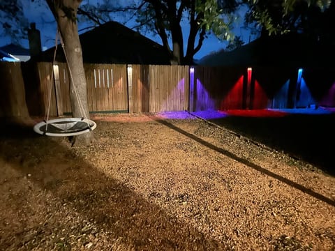 Large fenced backyard with eating area.