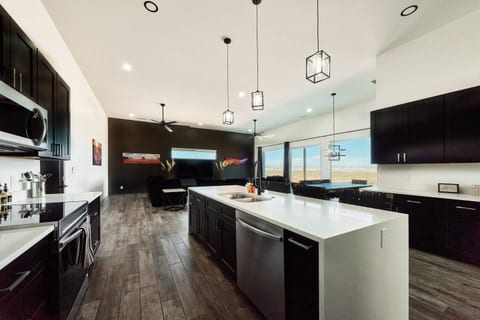 Kitchen with island that includes 4 bar stools for additional seating. 