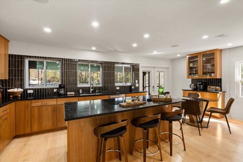 High end finishes and appliances in this chef worthy kitchen - all accoutrements included.

Multiple seating options at kitchen table and Island.

French doors provide access to screened in porch | wrap around deck overlooking canal.