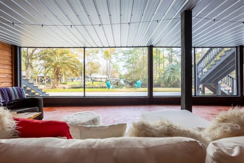 Spacious screened patio with cozy seating and serene waterfront views
