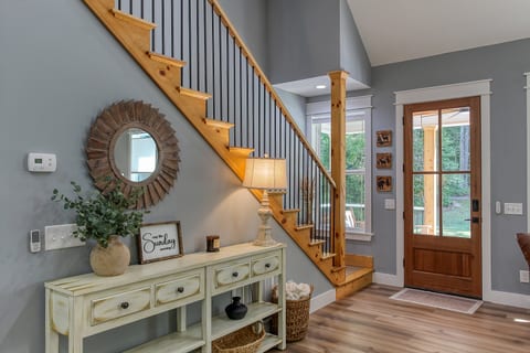 Warm wood accents and thoughtful touches welcome you inside Robbin’s Nest on Snowbird Creek, with stairs leading to the two upstairs queen bedrooms.