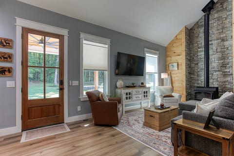 Settle into the inviting living room at Robbin’s Nest on Snowbird Creek, with comfortable seating, a smart TV, and natural light.