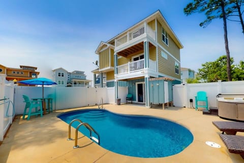 Beachside bliss and poolside views await you! Our property is a short stroll from the scenic Whalehead Beach, offering both a side view of the house and a relaxing pool view.