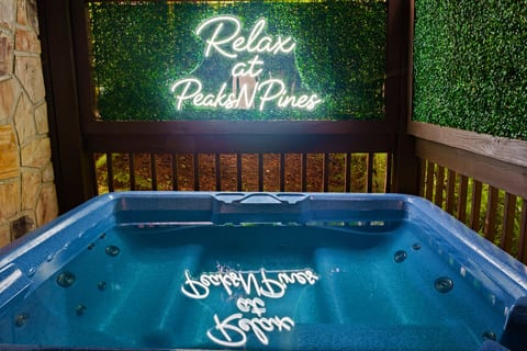 Private hot tub retreat with neon sign and cozy cabin vibes