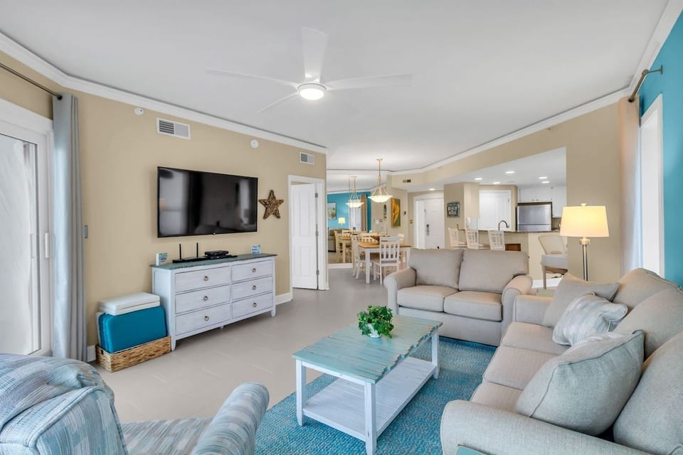 The living room area features a 65" LG Smart TV with Digital Cable and a queen size sofa sleeper, sheets provided