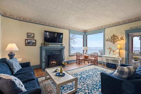 Spacious living room with fireplace and stunning Lake Michigan views