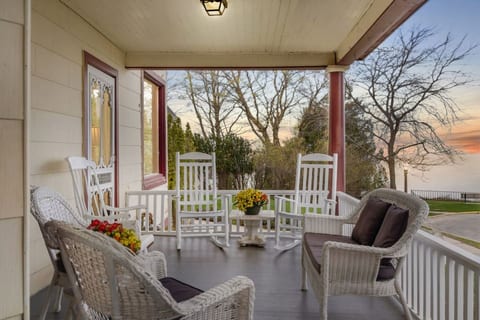 Inviting front porch with comfortable seating and lake views