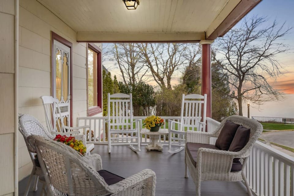 Inviting front porch with comfortable seating and lake views