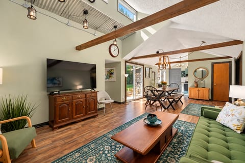 Open concept living and dining area at The Hideaway at Deer Creek, offering a comfortable gathering space for an East Jordan, Michigan vacation