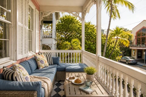 Relax on the spacious second floor porch with comfortable seating, surrounded by lush tropical landscaping and the beautiful architecture of historic Key West.