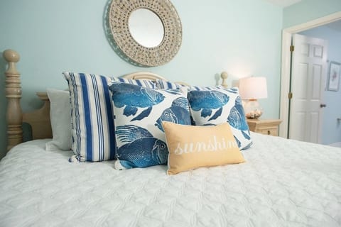 Primary Bedroom downstairs with King Sized bed and attached bath. Decorated beautifully in boho seaside decor.