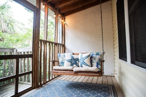 Back Porch swing with twinkly lights up in the trees!