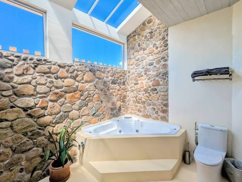 Private villa bathroom with hot tub.