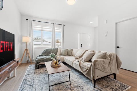 Open living room with 65-inch smart TV and fast WiFi — 5 minutes to West Edmonton Mall
