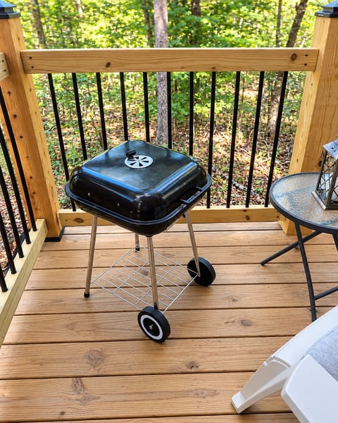 Private wooded deck with charcoal grill for easy outdoor cookouts