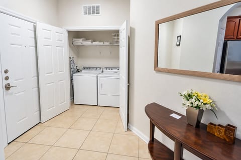 Bright entryway with in-unit washer/dryer and welcoming decor