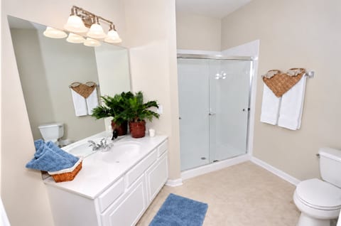 Bright spacious bathroom with large vanity and glass walk-in shower