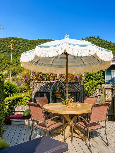 Wonderful outdoor deck with dining table comes right off the house from the Dutch door