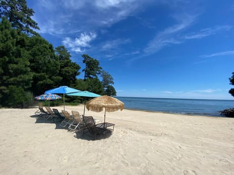 Have an exclusive beachfront with direct Chesapeake Bay access, featuring outdoor seating and umbrellas—perfect for relaxing, enjoying ocean breezes, and watching stunning sunsets right from the sand!