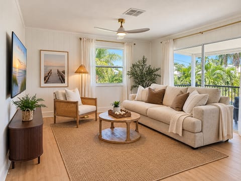 Bright coastal living room with tropical views and private balcony