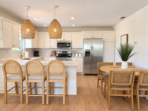 Bright modern kitchen with island seating and cozy dining space
