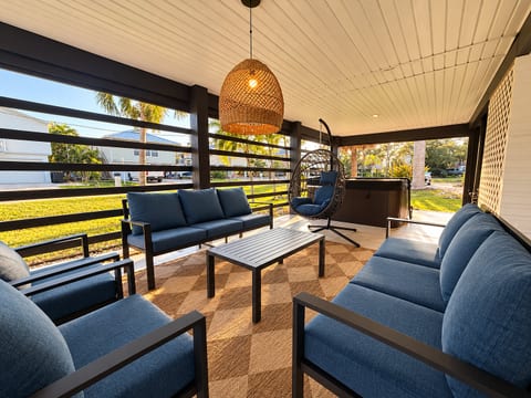 Relax on the covered porch with plush seating, egg chair & hot tub