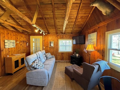 Living room with lake view and mounted TV