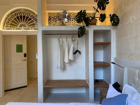 Bright boutique-style room with open closet, shelving, and high ceilings