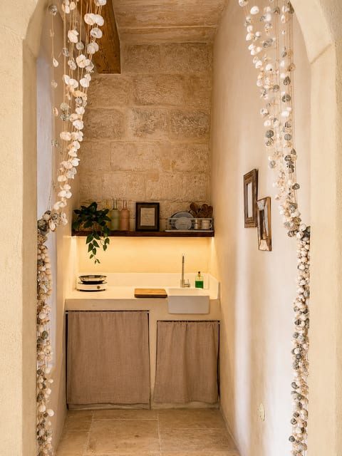 Charming stone kitchenette with warm lighting and coastal details