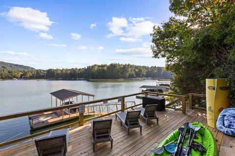 Private lakeside deck with dock, loungers, and kayaks ready to enjoy