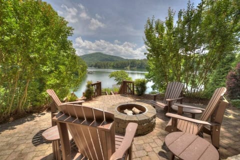 Outdoor patio with fire pit and seating for 4 overlooks the mountains and lake. Firewood not included but can be arranged for delivery.