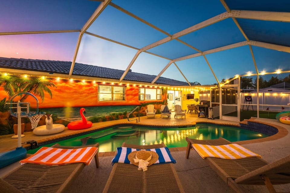 Screened tropical pool retreat with cozy lighting and resort-style vibes