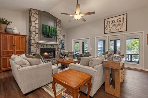 Cozy great room with stone fireplace, vaulted ceilings, and scenic views