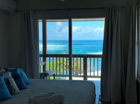 Ocean-view bedroom with sliding glass doors opening to the lanai.