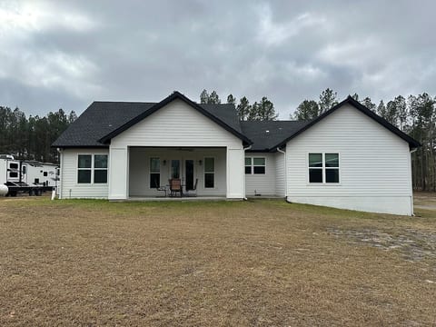 Back of home with porch