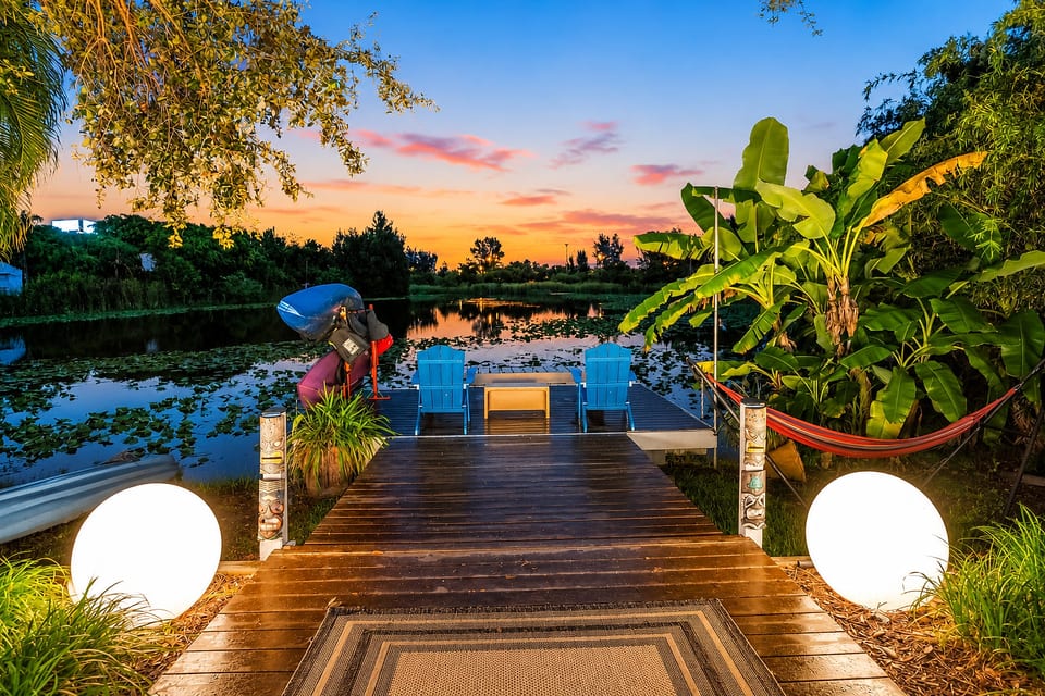 Private sunset dock with hammock, tropical gardens, and waterfront views