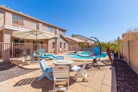 Relax outdoors with poolside seating and a spacious backyard setup.
