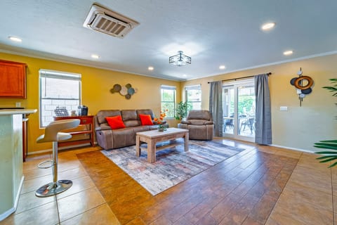Sunny living room with recliners, coffee bar, and patio doors