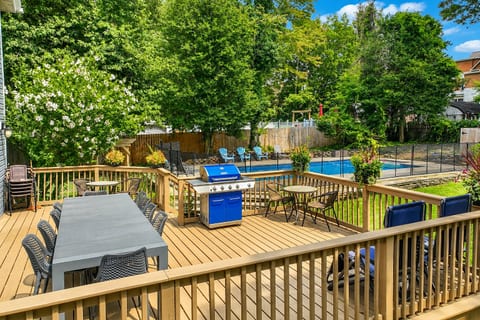 Spacious deck with grill, outdoor dining, and a private fenced pool
