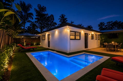 Private tropical villa with glowing pool and inviting outdoor lounge