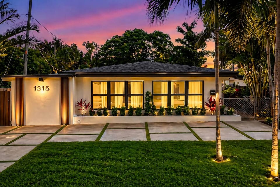 A stunning tropical retreat glowing at sunset, offering a warm and inviting entrance. Surrounded by lush greenery, this peaceful home sets the tone for a relaxing and memorable stay.