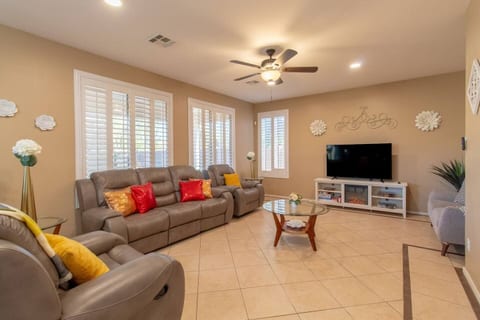 Bright, open living room with reclining sofas — perfect for relaxing together.