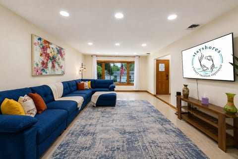 Bright living room with oversized sectional, big TV, and inviting open layout