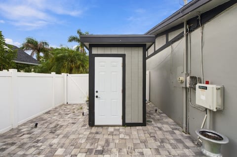Private paved side yard with storage shed and fenced outdoor space