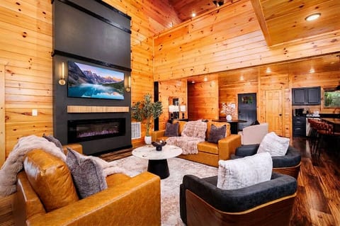 Cozy great room with soaring wood ceilings, fireplace, and open layout