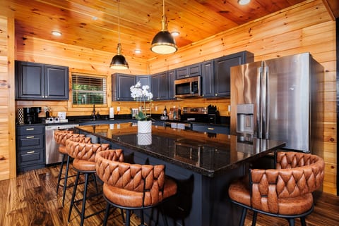 Rustic-chic kitchen with granite island seating and stainless appliances