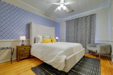 Stylish bedroom with plush bed, bold accent wall, and cozy seating