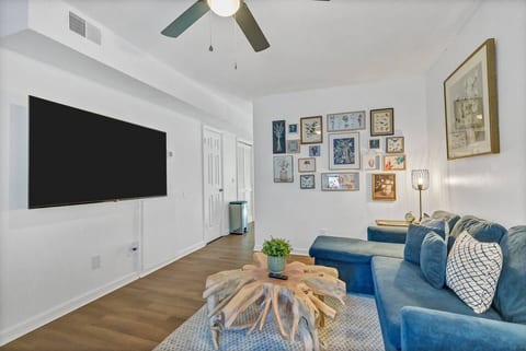 Bright living room with plush sectional, large TV, and stylish decor